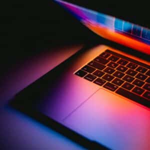 Laptop beside a keyboard on a table